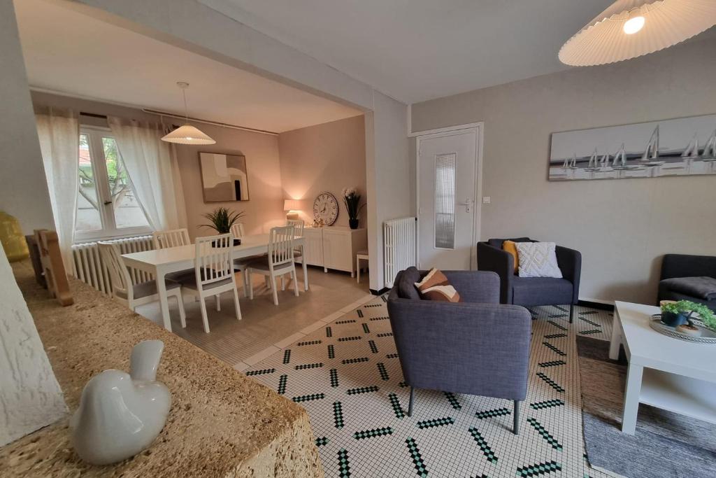 a living room with a couch and a table at Large family house 300m from the beach in Arcachon