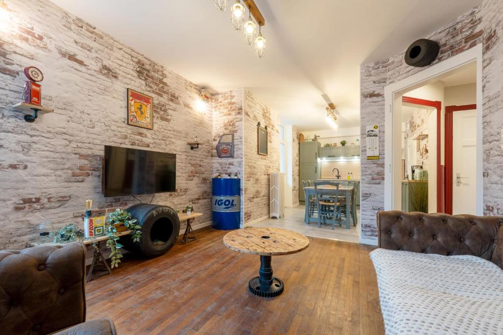 a living room with a couch and a table at The workshop in Metz