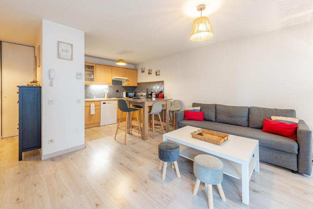 a living room with a couch and a table at 2 Rue du Parc in Annecy