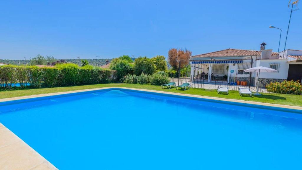 a swimming pool in the backyard of a house at El Olmo Posadas by Ruralidays in Posadas