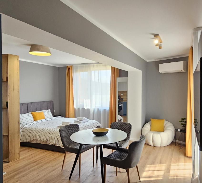 a bedroom with a bed and a table and chairs at By The Pool Apartments #10 in Velingrad