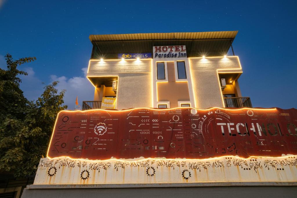 a house with lights on the front of it at FabHotel Paradise Inn in Indore