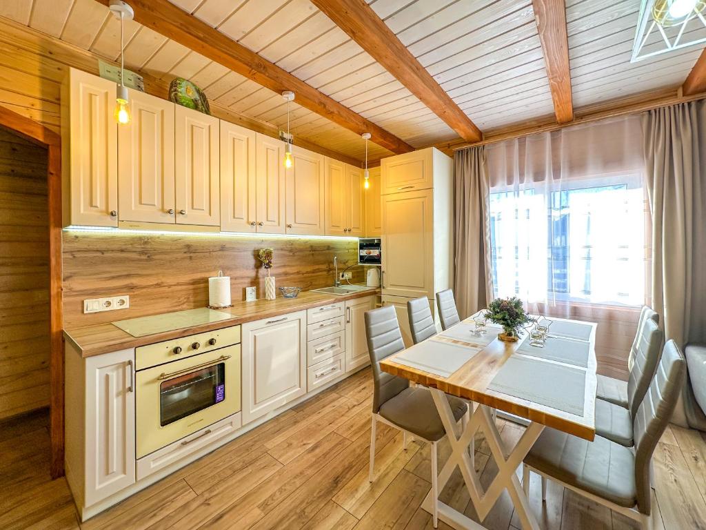 a kitchen with a table and a dining room at KaVacottage in Krivorovnya