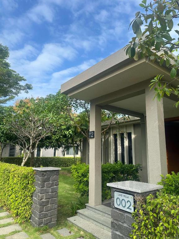 a house with a sign in front of it at Villa Coastar 002 Hồ Tràm in Ho Tram