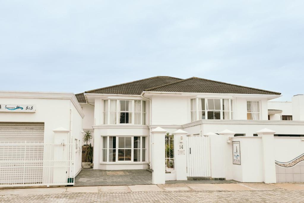 a white house with a garage at Summer House B&B in Gqeberha