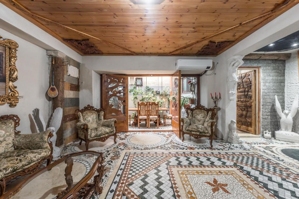 a living room with chairs and a rug at Kanuni Authentic Albanian House by PikHost in Shkodër