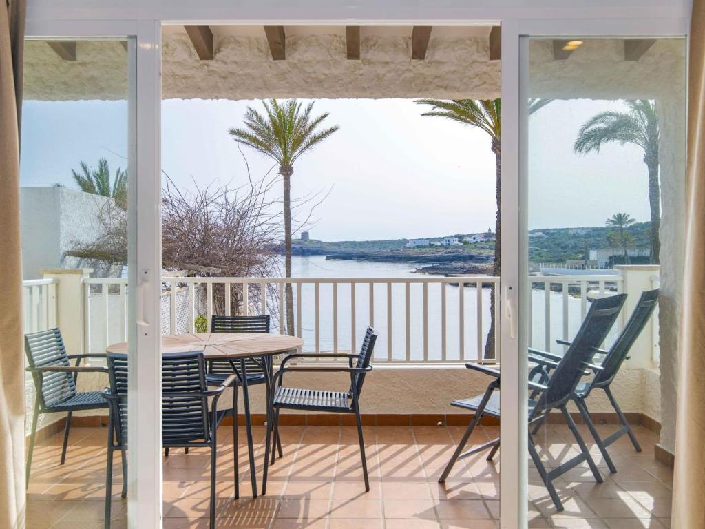 a patio with a table and chairs on a balcony at Villa Gavines Up in S'Algar