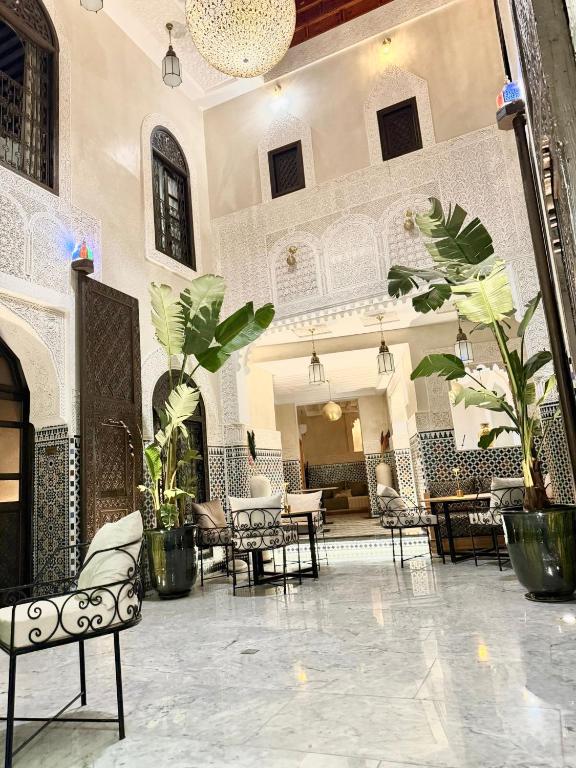 a lobby with chairs and tables in a building at Riad Citronnier & Spa in Fez