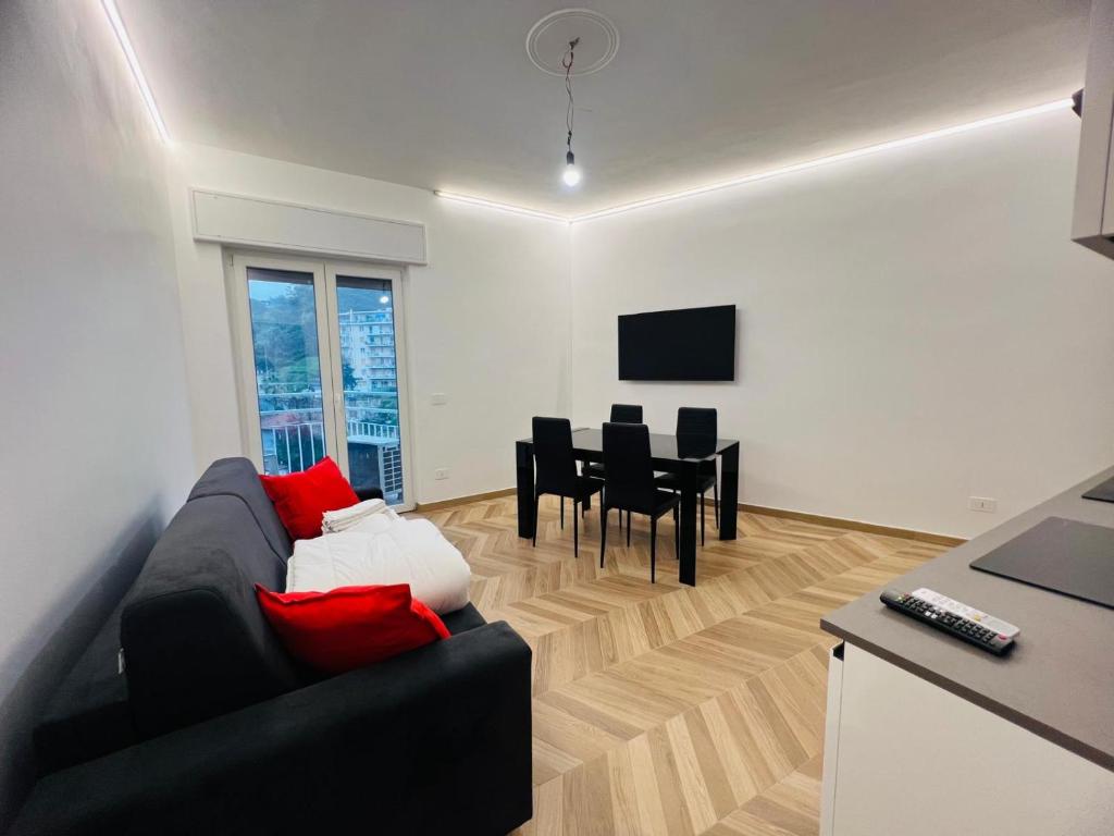 a living room with a couch and a dining room at Suite Borgo 112 - Sanremo in Sanremo