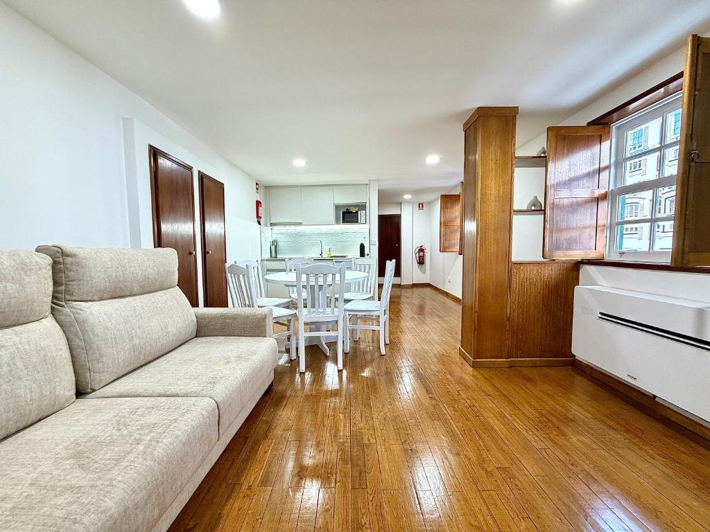 a living room with a couch and a table at Casa do Castello Chaves in Chaves