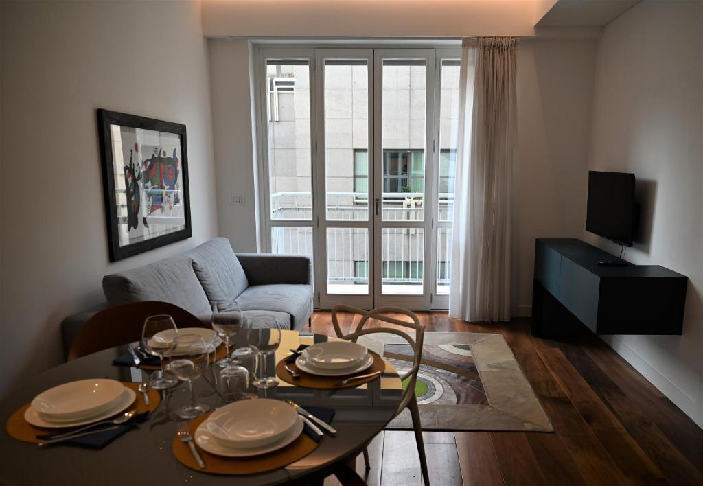 a living room with a table and a couch at Brera Elegant in Milan