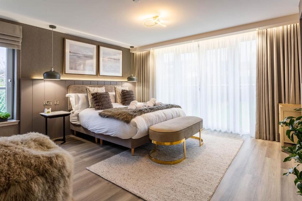a bedroom with a bed and a large window at Arran Shores Luxury Shorefront Apartment 8 in Lamlash