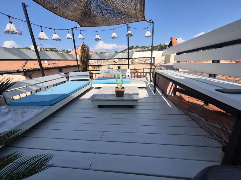a rooftop patio with a table and lights at CALANQUE D'EN VAU in Cassis