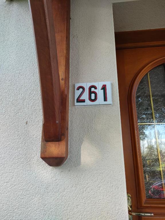 a sign on the side of a door with the number at chambre Chez sylvie in Allaire