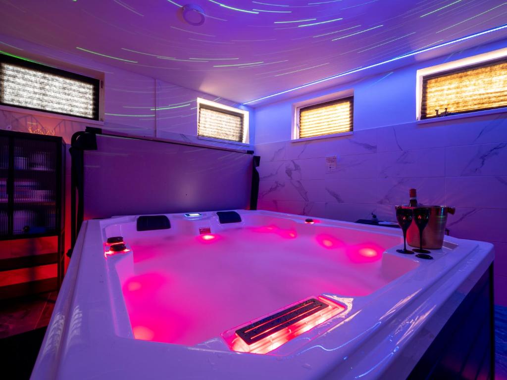 a hot tub with red lights in a room at Hideaway in Ostrava