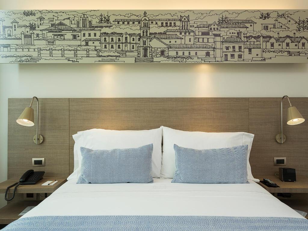 Postel nebo postele na pokoji v ubytování Hotel bh Usaquén