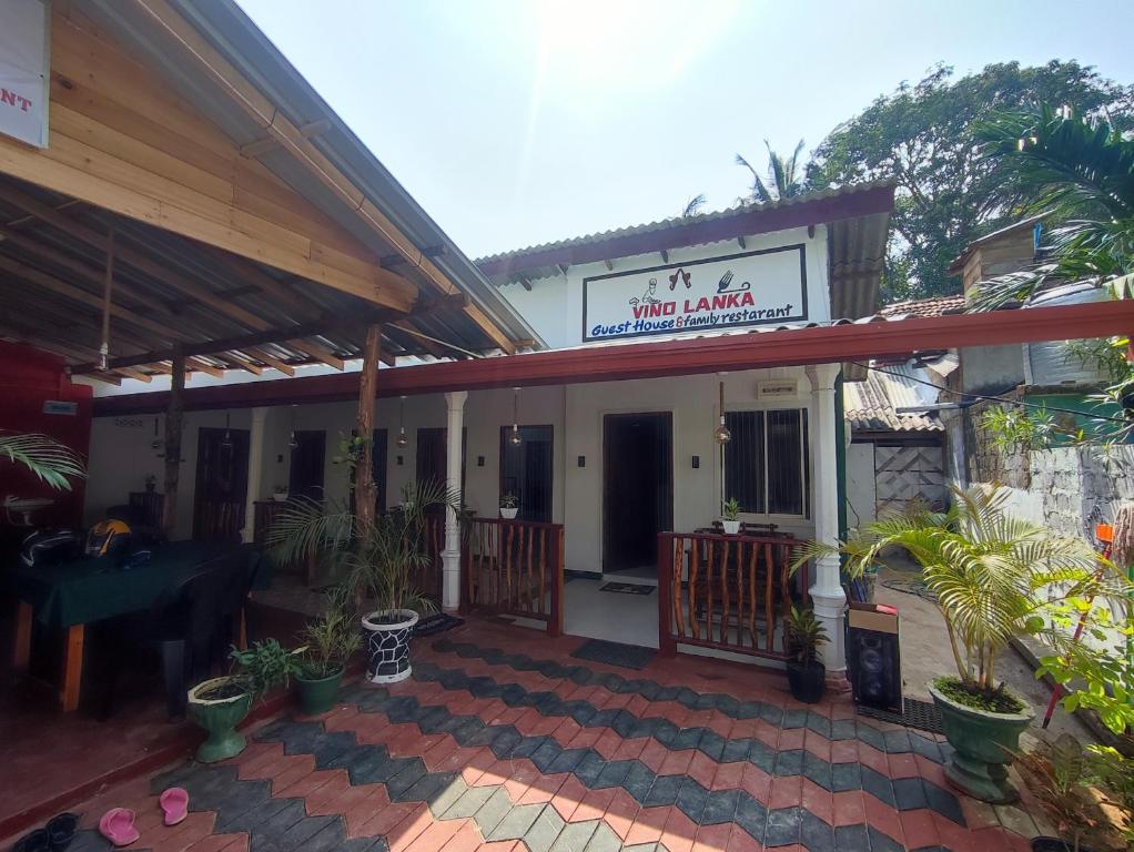 a building with a sign that reads hotel akhtar at Vino lanka in Trincomalee
