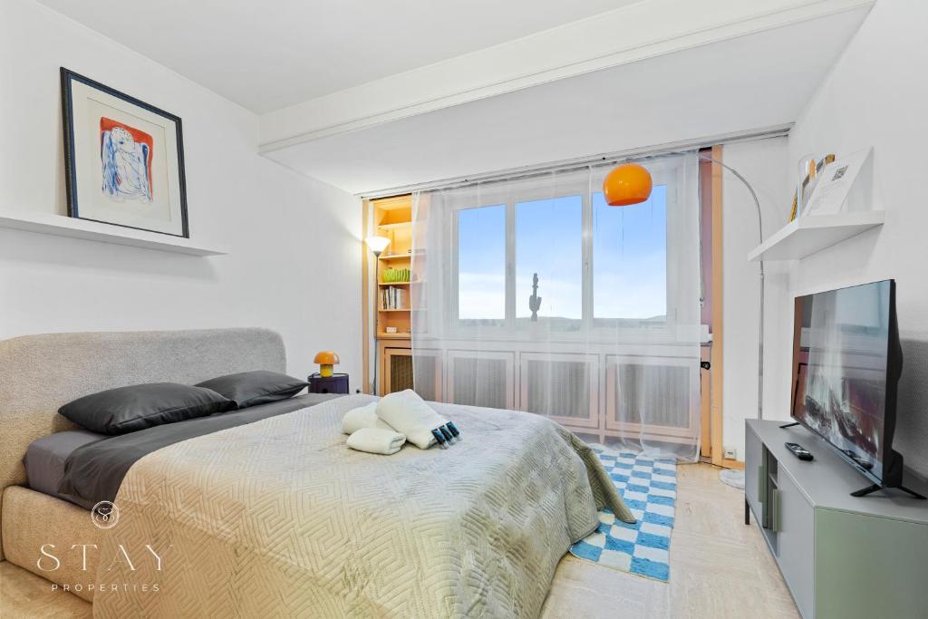 a bedroom with a large bed and a television at Appartement à Belair in Hollerich