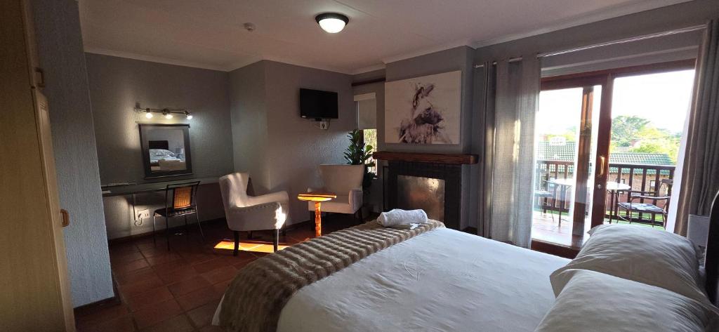 a hotel room with a bed and a balcony at Boabab at Greenway Woods in White River