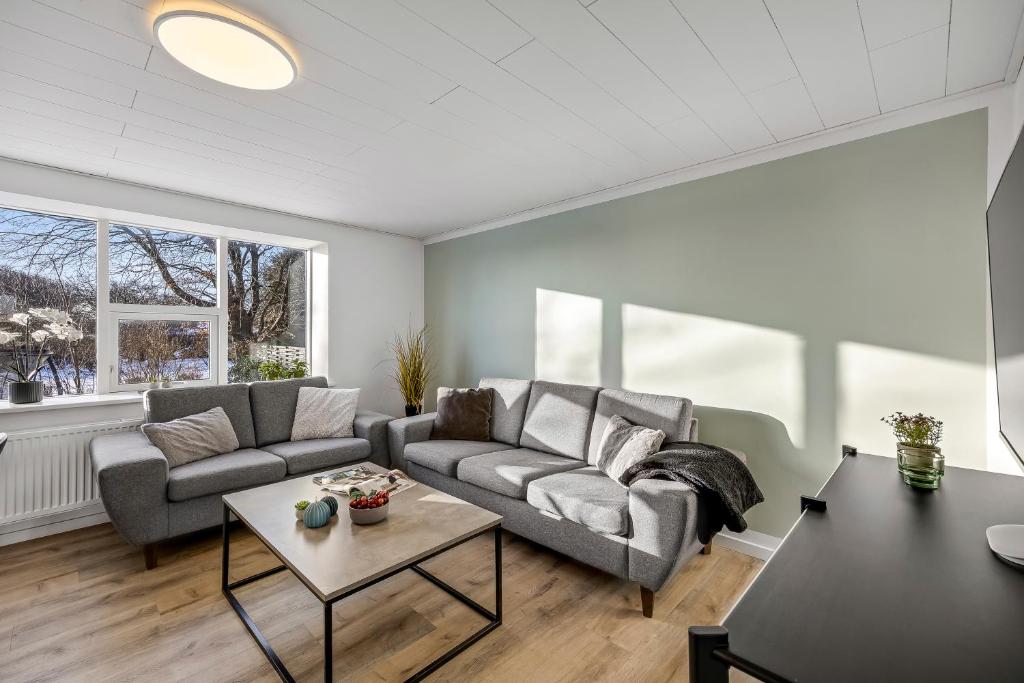 a living room with a couch and a table at FeWo Vidstrup Have in Vidstrup