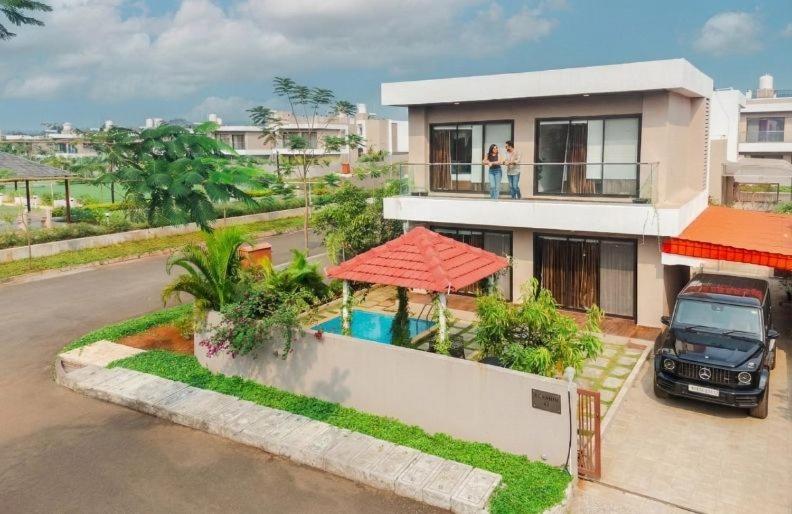 a house with a truck parked in front of it at EKOSTAY - Trinity Villa in Karjat