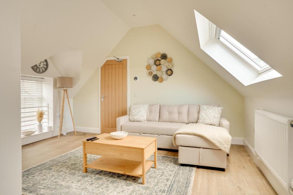 a living room with a couch and a table at Apt 3 Armatage Flats, Eyemouth in Eyemouth