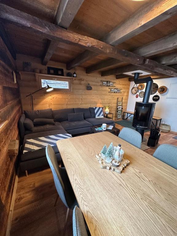 a living room with a table and a couch at Mayen unique et authentique in Vernamiège