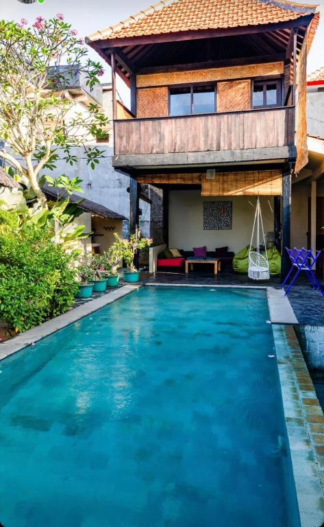 a villa with a swimming pool and a house at Garden House Balangan in Uluwatu