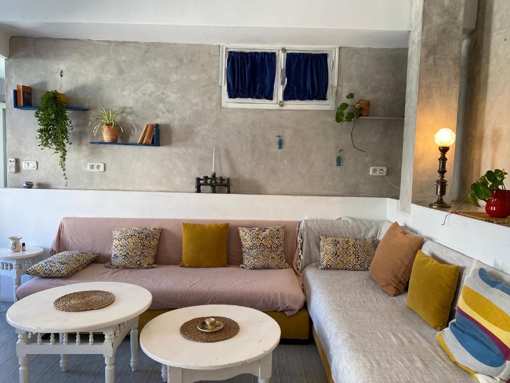 a living room with a couch and two tables at Birdhouse Sidi Bou Said in Dar Mimoun Bey
