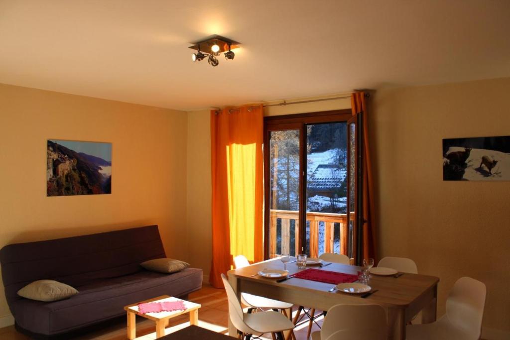 a living room with a couch and a table at Les biches in Roubion