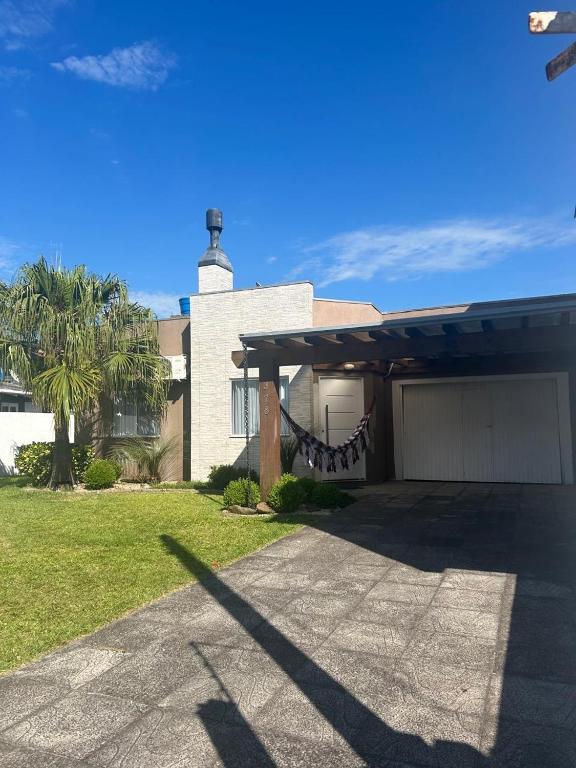 a house with a lighthouse on top of it at Casa de lazer e tranquilidade in Tramandaí