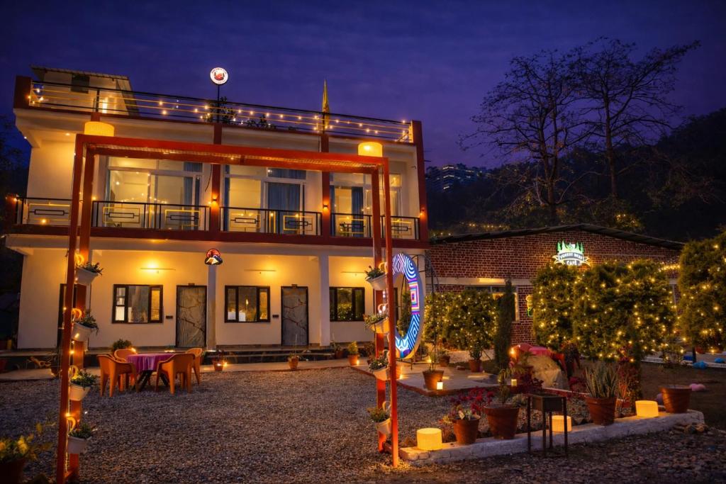 a building with a lot of lights in front of it at Forest Nest Farm Stay in Rājpur