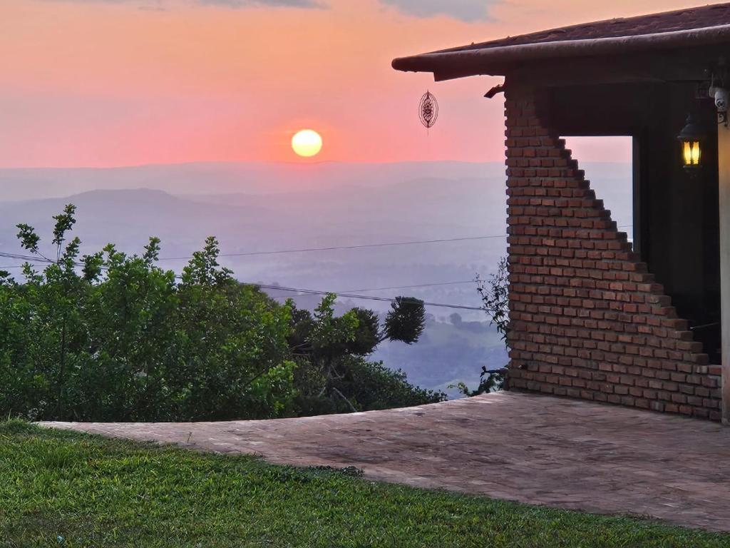 a house with the sunset in the background at Solar de Bonito in Bonito