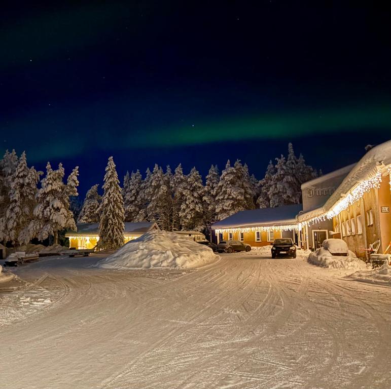 an image of the aurora in the sky over a building at Arctic Shaman Adventures -Jurtta in Köngäs