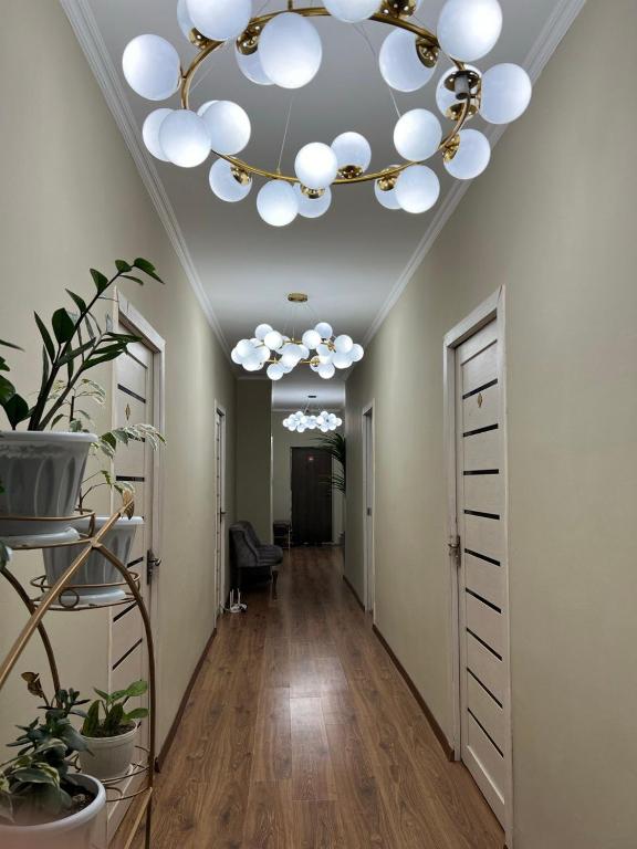 a hallway with a ceiling with a chandelier at Гостиница 888 in Zhezdi
