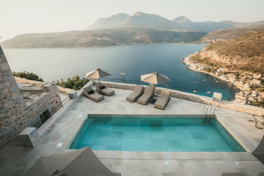 a swimming pool with a view of a body of water at Nest Limeni in Limeni