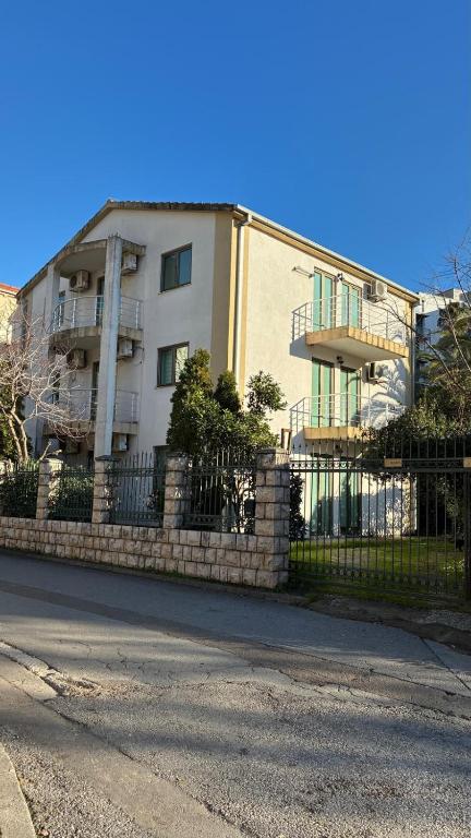 a building with a fence in front of a building at Apart Ludmila in Bečići