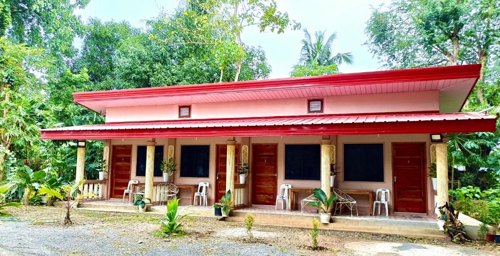 a red house with a red roof at Victoria's Inn in Siquijor