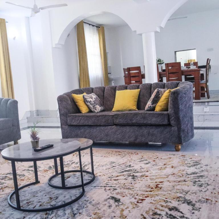 a living room with a couch and a table at Leah's Luxury Villa in Mombasa