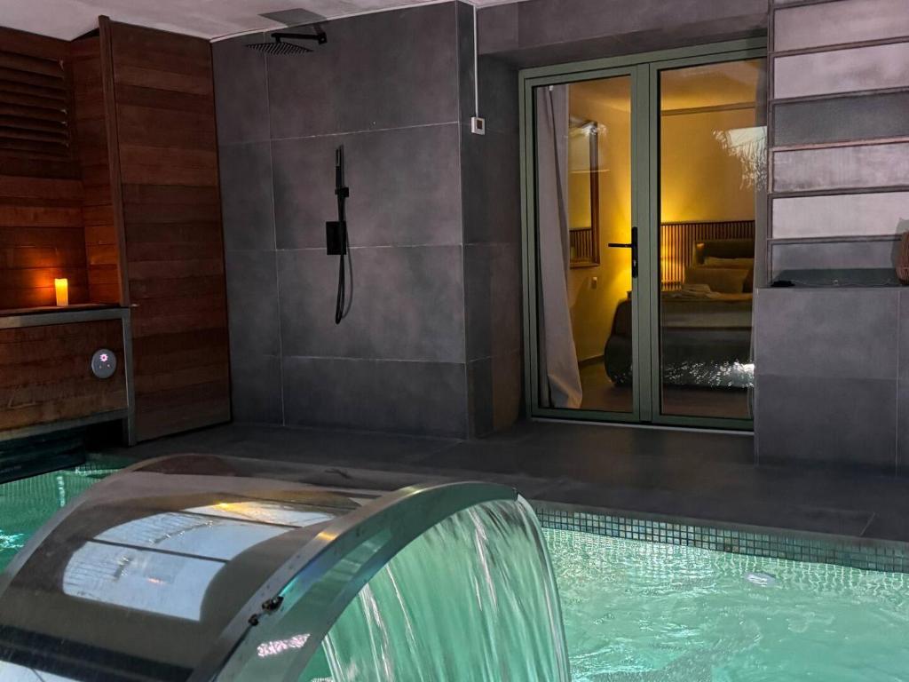 a swimming pool with a water slide in a house at SuitePoolBarcelona in Vilassar de Dalt