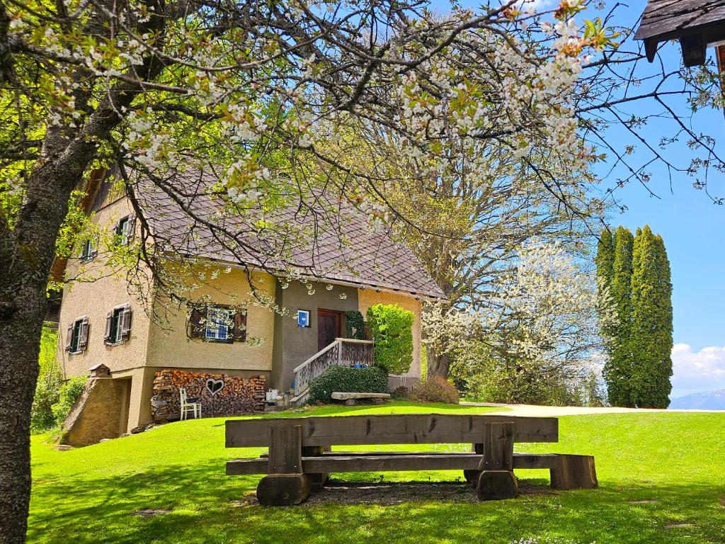 a park bench in front of a house at Roatmoaralm Almhütte in Rachau