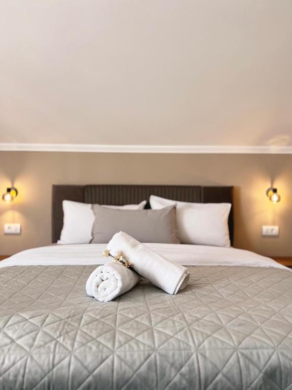 a towel laying on a bed in a bedroom at Apart Mi in Novi Sad