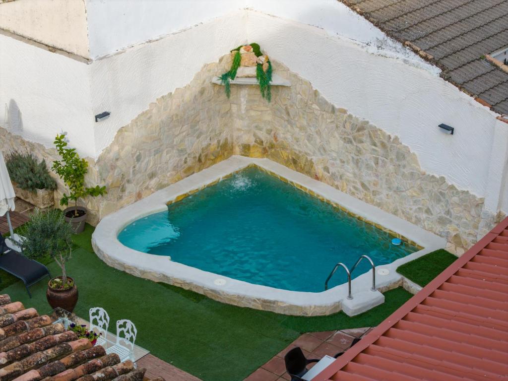 a man standing on the side of a swimming pool at Casa Los Templarios, Puy du fou Toledo in Burujón