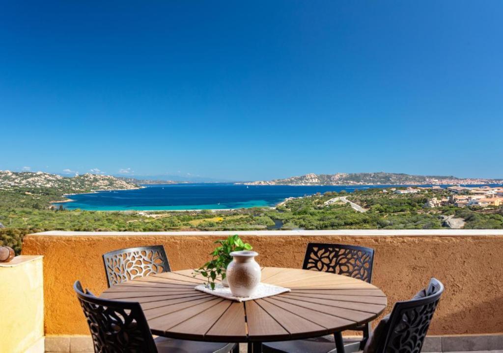 a table with chairs and a vase on it on a balcony at Horizon in Palau