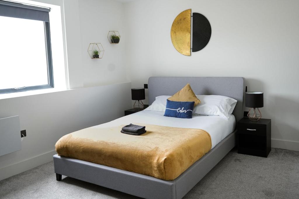 a bedroom with a bed with a mirror on the wall at Modern - City Centre - Free parking in Norwich