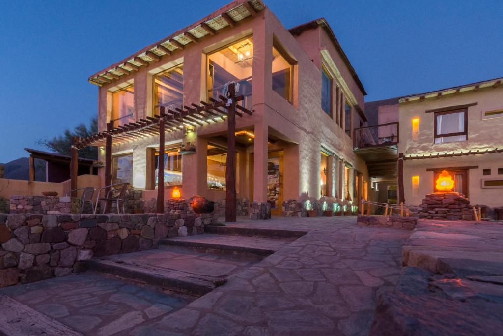 a large house with a lot of windows at La Posada del Rio in Tilcara