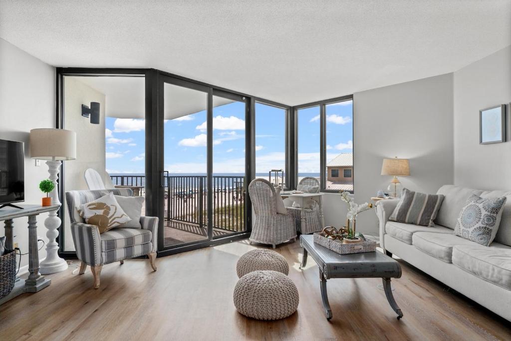 a living room with a couch and chairs at Beachfront Condo With Beautiful Sunset in Panama City Beach