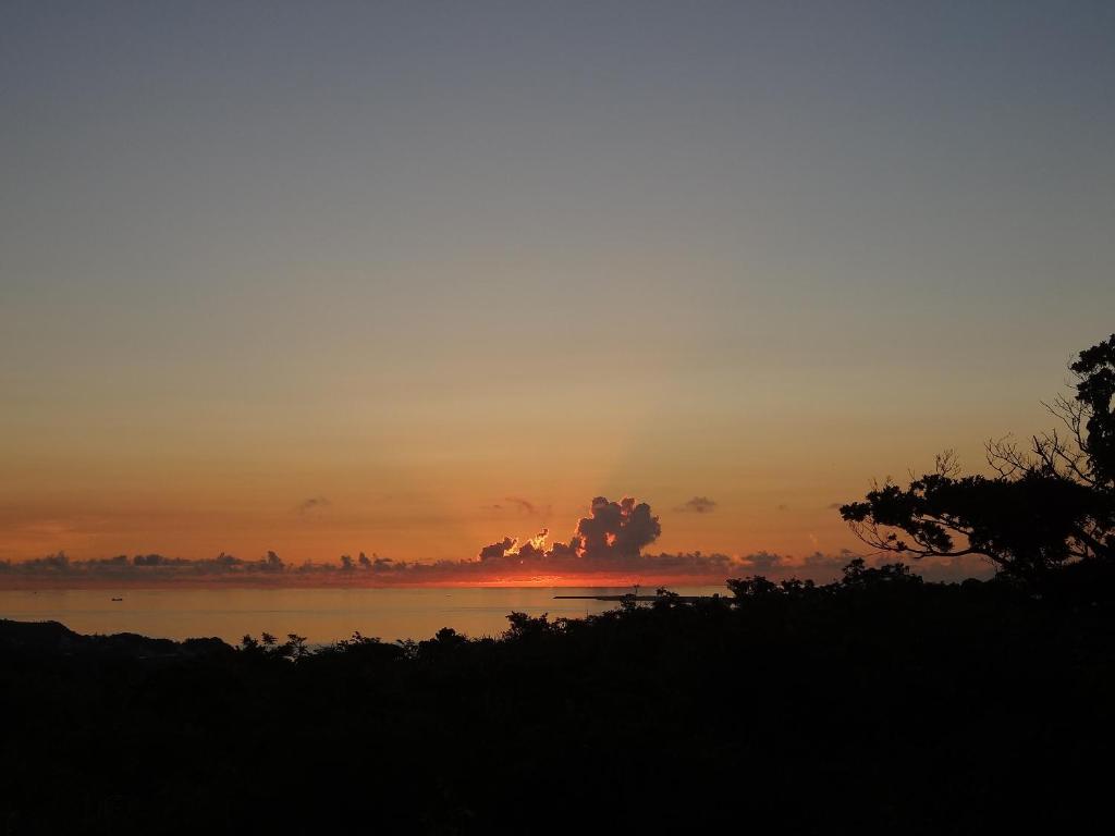 a sunset over a body of water at Asahinoyado Shidakaji in Nanjo