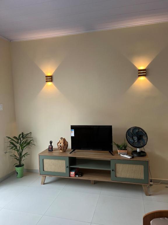 a living room with a table with a television on it at Casa do Sal in São Luís