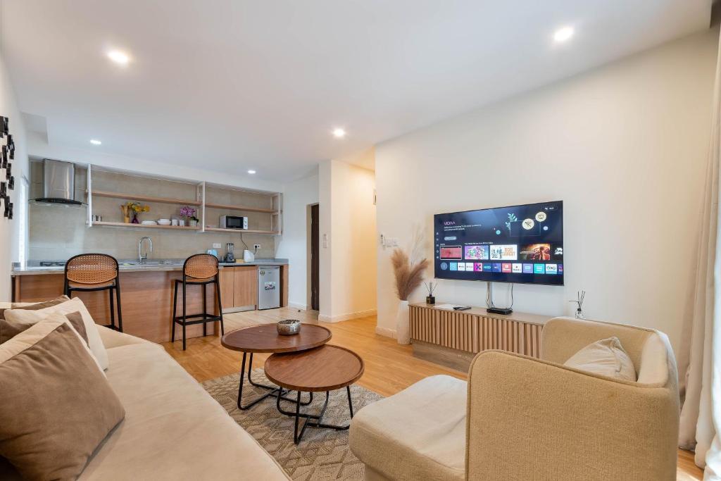 a living room with a couch and a kitchen at Aima Apartments in Lagos
